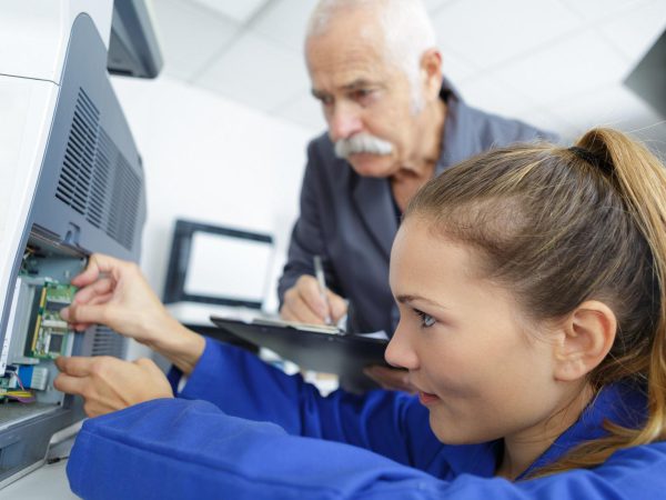 electromechanical technician repairing an appliance