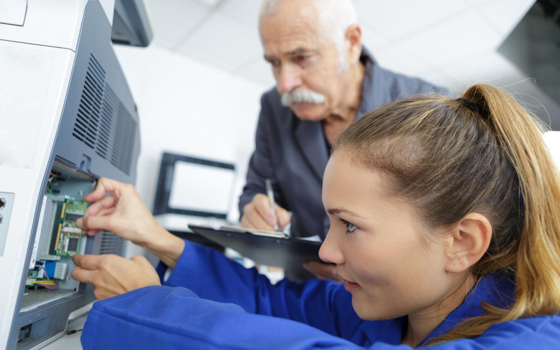 electromechanical technician repairing an appliance